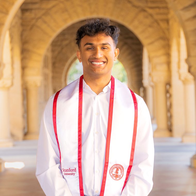 Aqib, wearing a Stanford University graduation stole, on Stanford's campus